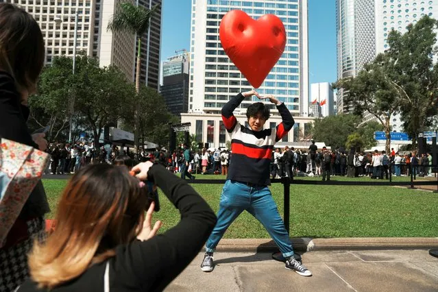Visitors pose for pictures with a giant inflatable heart called “Chubby Hearts”, an installation by designer Anya Hindmarch, on Valentine's Day in Hong Kong, China on February 14, 2024. (Photo by Lam Yik/Reuters)