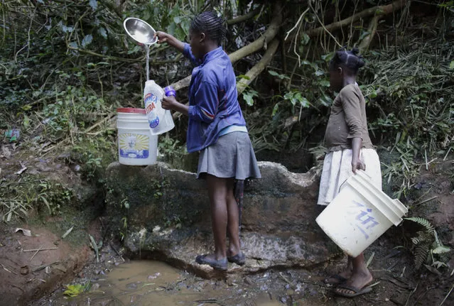 Two girls fill containers with water at a water source in Furcy, Haiti, February 23, 2016. March 22 marks World Water Day. (Photo by Andres Martinez Casares/Reuters)