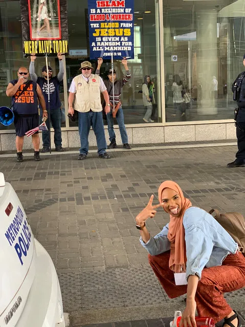Shaymaa Ismaa’eel, a 24-year-old Muslim woman passes by a group of angry protesters at an Islamic conference in Washington, DC on April 21, 2019. In response, she crouched in front of them and flashed a peace sign. The photo, posted on Instagram, prompted an outpouring of support. (Photo by Shaymaa Ismaa'eel/Instagram)