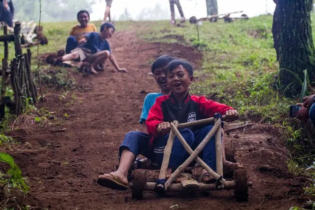 Children are riding Kadaplak in Kampung Pasir Angling, Bandung, Indonesia, on February 26, 2024. (Photo by Ryan Suherlan/NurPhoto/Rex Features/Shutterstock)