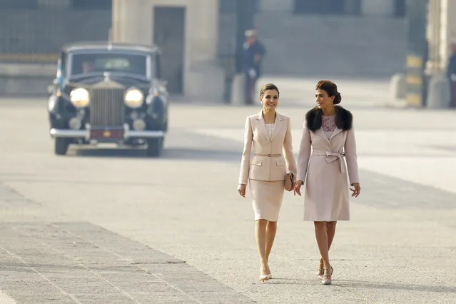 Spain's Queen Letizia, left, walks with Juliana Awada, the wife of the Argentina's President Mauricio Macri, during a welcome ceremony at the Royal Palace in Madrid, Wednesday, February 22, 2017. Macri and his wife Awada are on the first of a four day official visit to Spain. (Photo by Francisco Seco/AP Photo)
