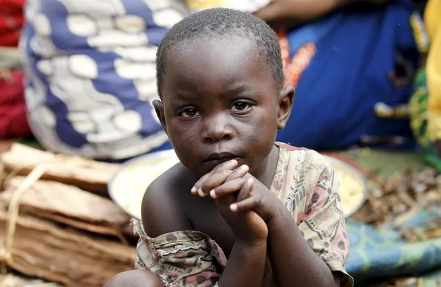 A Burundian refugee child is pictured on the shores of Lake Tanganyika in Kagunga village in Kigoma region in western Tanzania, as they wait for MV Liemba to transport them to Kigoma township, May 18, 2015. (Photo by Thomas Mukoya/Reuters)