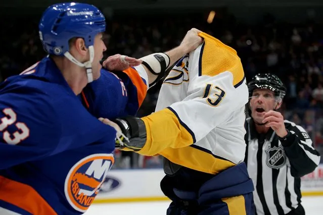 New York Islanders defenseman Zdeno Chara (33) fights Nashville Predators center Yakov Trenin (13) during the first period at UBS Arena in Elmont, New York, USA on December 9, 2021. (Photo by Brad Penner/USA TODAY Sports)