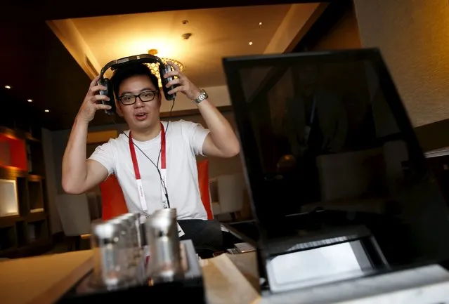 An invited guest enjoys a private listening experience of a test unit of the Sennheiser HE 1 sound system, which is expected to retail for about S$77370 ($55000), in a hotel suite during the CanJam headphone and personal audio expo in Singapore February 21, 2016. (Photo by Edgar Su/Reuters)