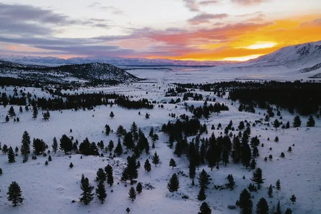 In this drone photo provided by Mammoth Mountain Ski Area, MMSA, snow continues falling in Mammoth Mountain in Mammoth Lakes, Calif., early Wednesday, December 15, 2021. Another storm is pushing into California as the state cleans up from a powerful weather system that coated mountains with much-needed snow and set rainfall records in the drought-stricken state. Wednesday's storm is expected to mostly impact Northern California. (Photo by Sammy Deleo/MMSA via AP Photo)