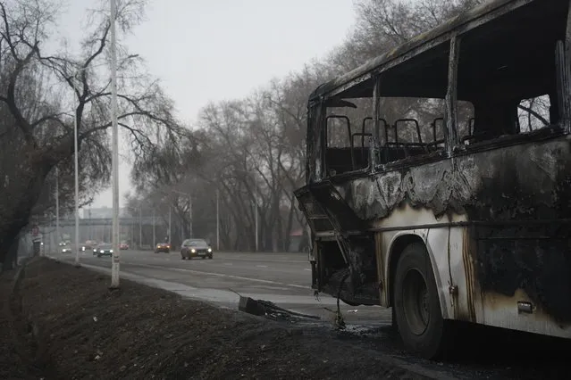 A bus, which was burned during clashes, is seen on a street in Almaty, Kazakhstan, Sunday, January 9, 2022. Kazakhstan's health ministry says 164 people have been killed in protests that have rocked the country over the past week. President Kassym-Jomart Tokayev's office said Sunday that order has stabilized in the country and that authorities have regained control of administrative buildings that were occupied by protesters, some of which were set on fire. (Photo by Vladimir Tretyakov/NUR.KZ via AP Photo)