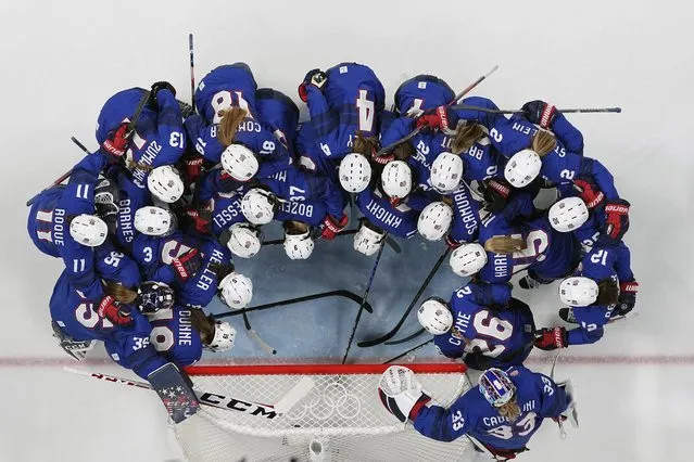 United States players gather before a preliminary round women's hockey game against Canada at the 2022 Winter Olympics, Tuesday, February 8, 2022, in Beijing. (Photo by Petr David Josek/AP Photo)