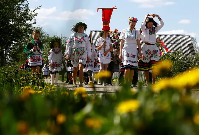 Villagers take part in a ritual celebrating the pagan god Yurya and pray for plentiful future harvests in the village of Pogost, Belarus May 6, 2016. (Photo by Vasily Fedosenko/Reuters)
