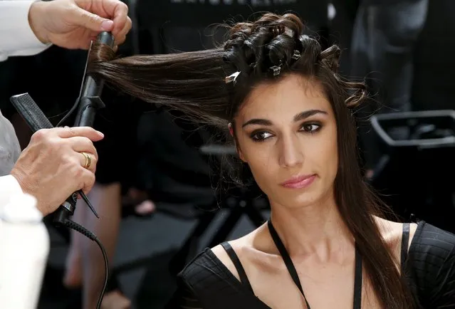 A model gets her hair made for the fashion show of Guido Maria Kretschmer at Berlin Fashion Week Spring/Summer 2016 in Berlin, Germany, July 8, 2015. (Photo by Fabrizio Bensch/Reuters)