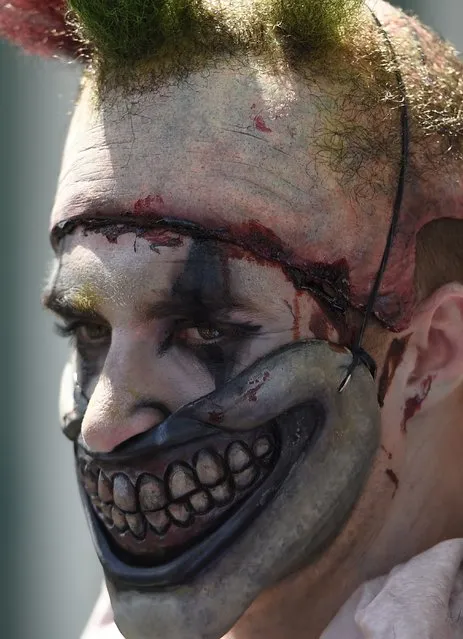 An attendee in a scary clown costume is seen on the third day of Comic Con International in San Diego, California, July 11, 2015. (Photo by Robyn Beck/AFP Photo)