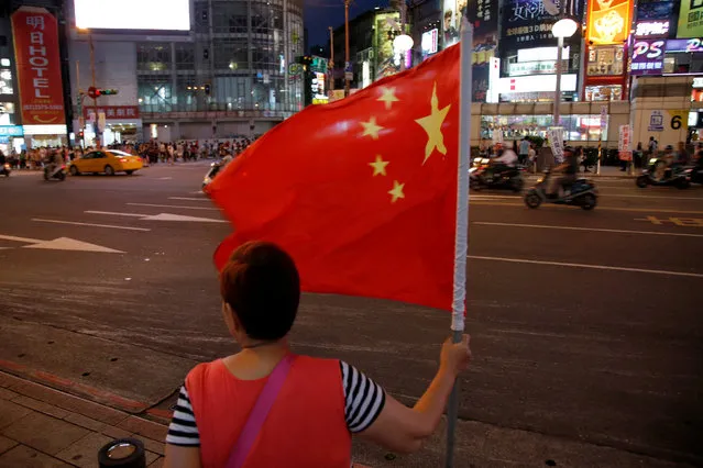 A pro-China supporter holds a China national flag during a rally calling for peaceful reunification, days before the inauguration ceremony of President-elect Tsai Ing-wen, in Taipei, Taiwan May 14, 2016. (Photo by Tyrone Siu/Reuters)
