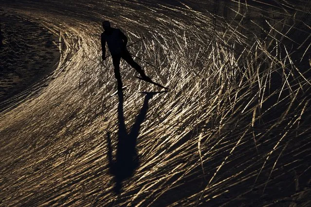A skier trains during a cross-country skiing training session at the 2022 Winter Olympics, Monday, February 14, 2022, in Zhangjiakou, China. (Photo by John Locher/AP Photo)