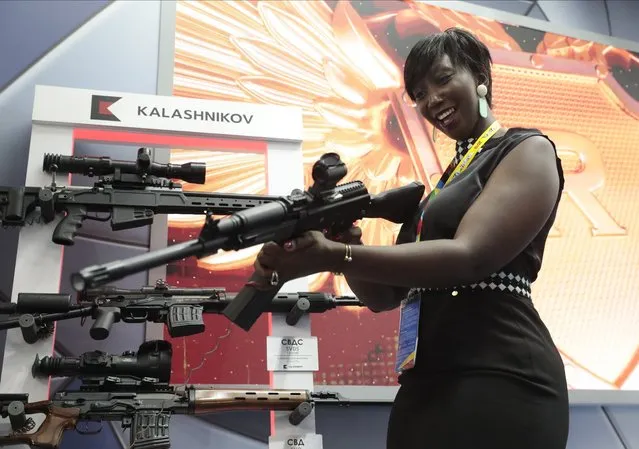 A visitor handles a gun at an exhibition by the Kalashnikov company on the sidelines of the Russia-Africa summit in the Black Sea resort of Sochi, Russia on Oct. 24, 2019. Amid a worldwide chorus of condemnation against Russia's war on Ukraine, Africa has remained mostly quiet – a reminder of the Kremlin's considerable influence over the continent. (Photo by Sergei Chirikov, Pool Photo via AP Photo, File)