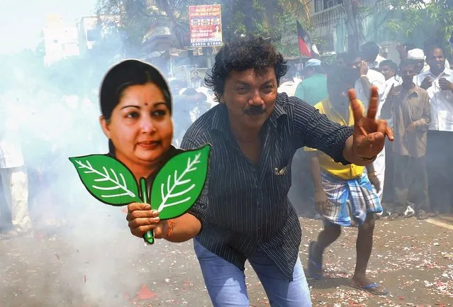 A supporter holds up a placard bearing the portrait of southern Indian state of Tamil Nadu Chief Minister and General Secretary of The All India Anna Dravida Munnetra Kazhagam (AIADMK) Party J. Jayalalithaa during celebrations in Chennai on May 16, 2014. (Photo by AFP Photo/STR)