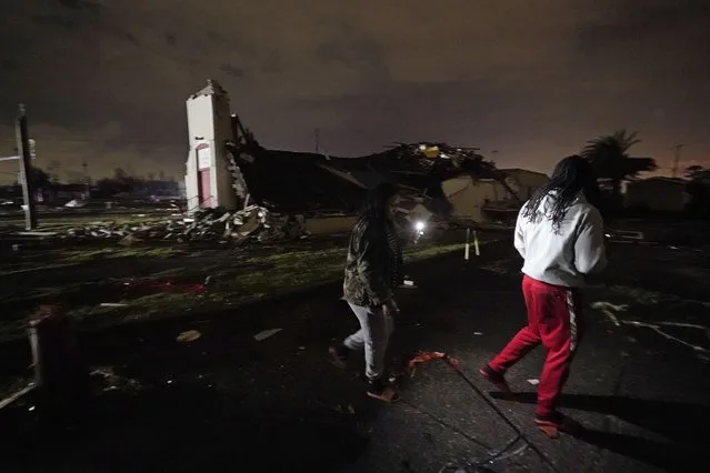 Breign Collins and Darryl Bardell, right, walk past a destroyed church after a tornado struck the area in Arabi, La., Tuesday, March 22, 2022. A tornado tore through parts of New Orleans and its suburbs Tuesday night, ripping down power lines and scattering debris in a part of the city that had been heavily damaged by Hurricane Katrina 17 years ago. (Photo by Gerald Herbert/AP Photo)