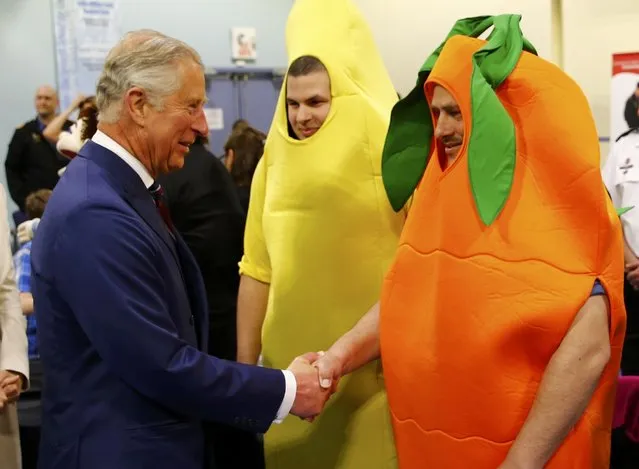 Britain's Prince Charles (L) greets men dressed as fruits and vegetables during a visit to the Military Family Resource Centre in Halifax, Nova Scotia, May 19, 2014.  The men are part of a program at the centre that promotes healthy eating for childrren. The royal couple are on a four-day visit to Canada that begins in Halifax and includes stops in Pictou, Nova Scotia, the Prince Edward Island towns of Charlottetown, Bonshaw and Cornwall and concludes in Winnipeg. (Photo by Mark Blinch/Reuters)