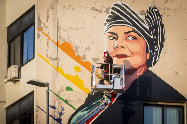 The street artist Laika adds the finishing touches to a mural in memory of the Italian writer Michela Murgia in Rome, Italy on July 8, 2024. (Photo by Alessandro Serranò/Rex Features/Shutterstock)