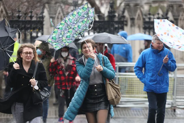Members of the public brace the wind and wet weather in Westminster central London following Storm Euniceon Friday, February 18, 2022. (Photo by James Manning/PA Images via Getty Images)