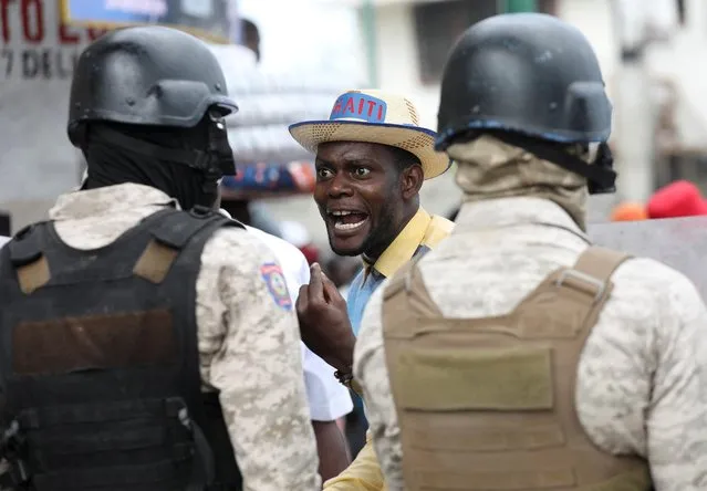 A demonstrator faces police during protests demanding that the government of Prime Minister Ariel Henry do more to address gang violence including constant kidnappings, in Port-au-Prince, Haiti on March 29, 2022. (Photo by Ralph Tedy Erol/Reuters)