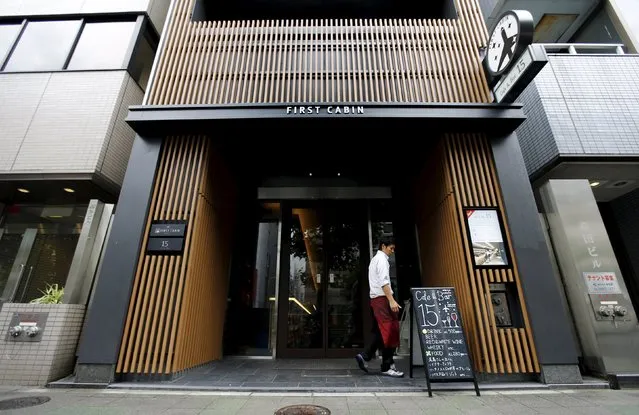 A man walks near the entrance of First Cabin hotel, which was converted from an old office building, in Tokyo, July 3, 2015. (Photo by Toru Hanai/Reuters)