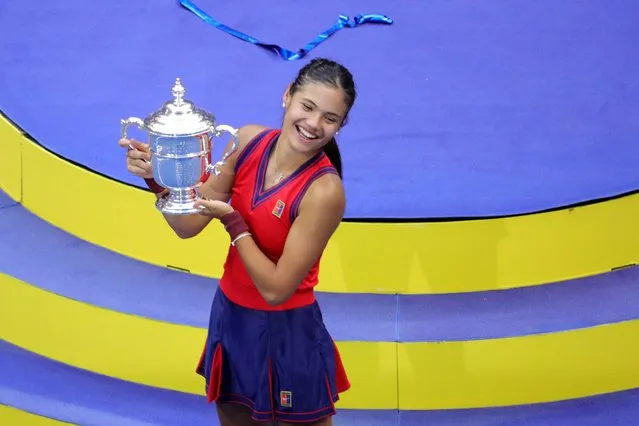 Britain's Emma Raducanu celebrates with the trophy after winning the 2021 US Open Tennis tournament women's final match against Canada's Leylah Fernandez at the USTA Billie Jean King National Tennis Center in New York, on September 11, 2021. (Photo by Kena Betancur/AFP Photo)