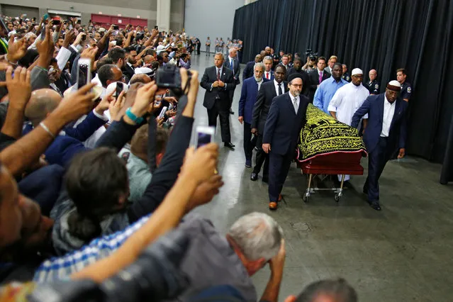 Worshipers and well-wishers take photographs as the casket with the body of the late boxing champion Muhammad Ali is brought for his jenazah, an Islamic funeral prayer, in Louisville, Kentucky, U.S. June 9, 2016. (Photo by Carlos Barria/Reuters)