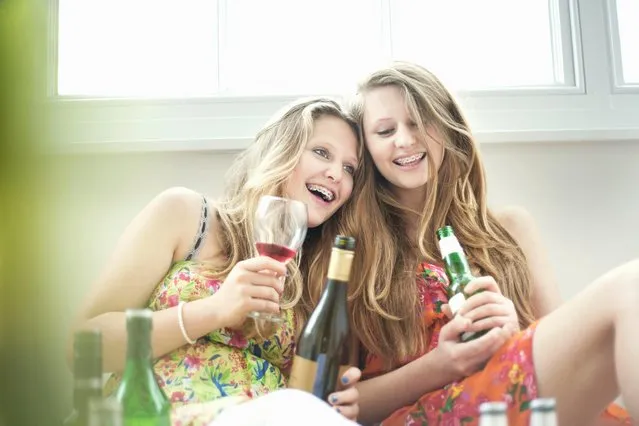 Teenage girls drinking alcohol together. (Photo by Cultura/Seb Oliver/Getty Images)