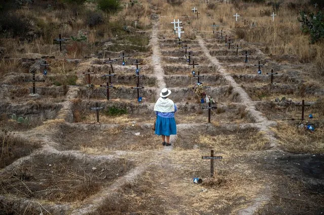 Adelina Garcia, 58, talk with AFP close at La Hoyada. A place with crosses with the names of the victims of forced disappearances, in Ayacucho on September 17, 2021. A place where the remains of two cement kilns that served to burn more than 100 peoplo were found. The relatives of Peruvians disappeared amid the internal conflict between 1980 and 2000 demand the remains of the leader of the Maoist guerrilla group Shining Path, Abimael Guzman, who died a week ago in prison, to be cremated and given to his relatives, avoiding his grave to become a place of worship. (Photo by Ernesto Benavides/AFP Photo)