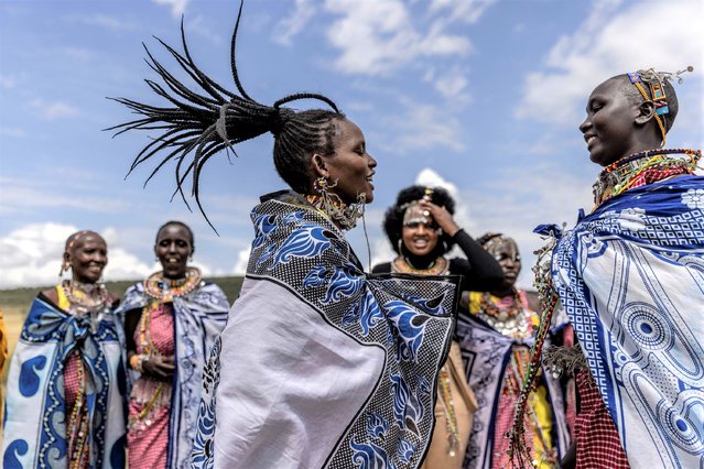 A group of Maasai women sing traditional songs during a Maasai cultural festival in Sekenani, on June 10, 2023. The Maasai people are a Nilotic ethnic group inhabiting Kenya and northern Tanzania. The Maasai cultural festival is a popular gathering and celebration of the Maasai cultural heritage and aims to showcase the community's traditional activities and fashion. (Photo by Luis Tato/AFP Photo)