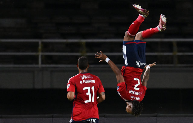 Independiente Medellin's defender Leyser Chaverra (R) celebrates after scoring from the penalty spot during the Copa Sudamericana round of 16 second leg football match between Colombia's Independiente Medellin and Chile's Palestino at the Hernan Ramirez Villegas stadium in Pereira, Colombia on August 21, 2024. (Photo by Raul Arboleda/AFP Photo)
