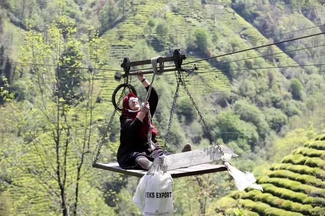 A woman is seen getting on a primitive cable car in Rize, Turkiye on April 27, 2022. Four families and landowners living in Daginiksu district of Rize reach their houses and lands, which cannot be reached by car because there is no road, by a cable car built with primitive methods. (Photo by Muhittin Sandikci/Anadolu Agency via Getty Images)