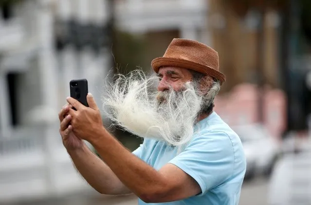 A man's facial hair blows in the wind as he takes a selfie along the waterfront ahead of the arrival of Hurricane Dorian in Charleston, South Carolina, September 4, 2019. The howling west flank of Hurricane Dorian soaked the Carolinas, flooding coastal towns, downing trees and whipping up occasional tornadoes a couple of days after reducing parts of the Bahamas to rubble. (Photo by Randall Hill/Reuters)