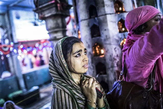 A young Sufi Muslims devoteecries as she clasps her hands in prayer at the 'dargah' or shrine of Sufi saint Muhammad Moin-ud-din Chisti on May 22, 2012 in Ajmer, India