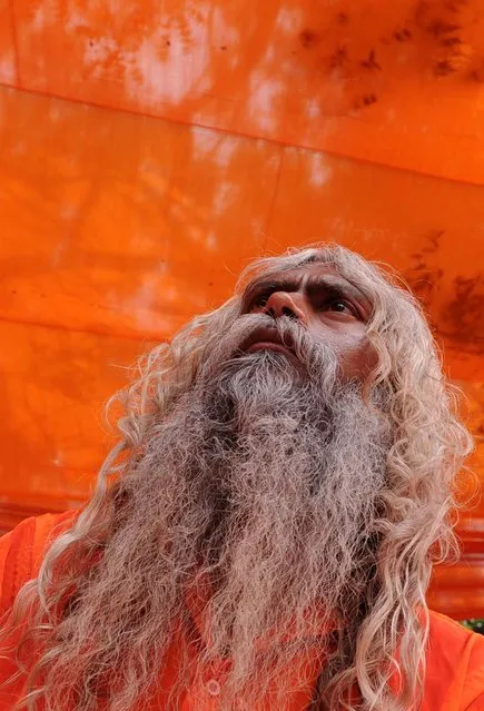 An Indian Sadhu, holy man, looks up while protesting to stop Indian government plans to construct dams on the river Ganges which would interrupt its flow, during a rally in New Delhi on June 18, 2012