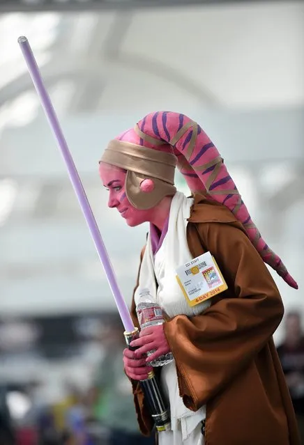 Christine Dennis talks with friends as she wears her Star Wars costume on day 1 of the 2014 Comic-Con International Convention, July 24, 2014, in San Diego. (Photo by Denis Poroy/Invision/AP Photo)