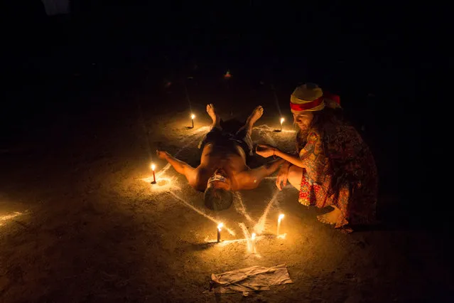 A man lies on the floor during a ritual at the Sorte Mountain on the outskirts of Chivacoa, in the state of Yaracuy, Venezuela October 10, 2015. (Photo by Marco Bello/Reuters)