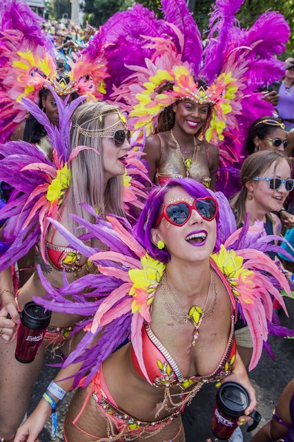 Dancers in costume dance behind their float at Notting Hill Carnival on August 28, 2017 in London, England. Notting Hill Carnival the annual event on the streets of the Royal Borough of Kensington and Chelsea, over the August bank holiday weekend. It is led by members of the British West Indian community, and attracts around one million people annually, making it one of the world's largest street festivals. (Photo by Guy Bell/Rex Features/Shutterstock)
