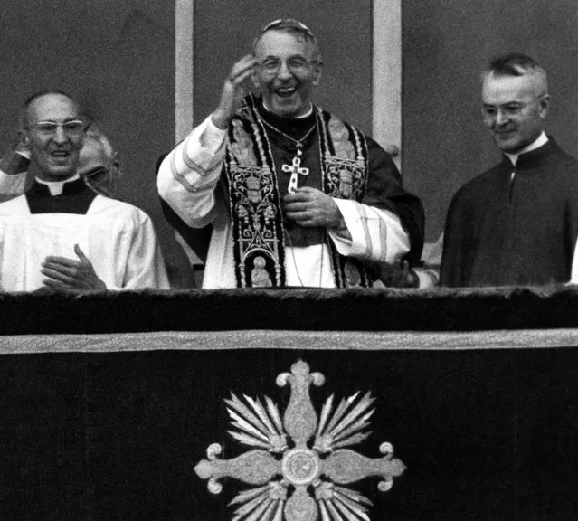 Pope John Paul I smiles and waves with both hands to crowd filling St. Peter's Square August 26, 1978 when the former patriarch of Venice appeared on the balcony of St. Peter's Basilica, short time after the white smoke coming out of the chimney of the Sistine Chapel, indicating that the conclavists had elected a successor for Pope Paul VI. (Photo by AP Photo)