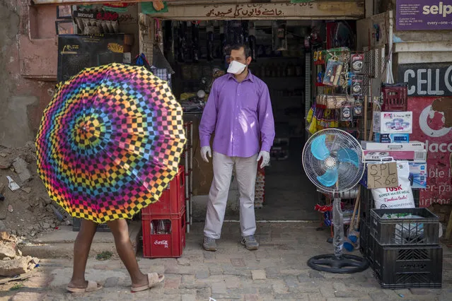 Iftikhar Ahmad, a Pakistani shopkeeper, is one of the very few wearing a mask in the Diepsloot township north of Johannesburg, South Africa, Saturday March 21, 2020. (Photo by Jerome Delay/AP Photo)