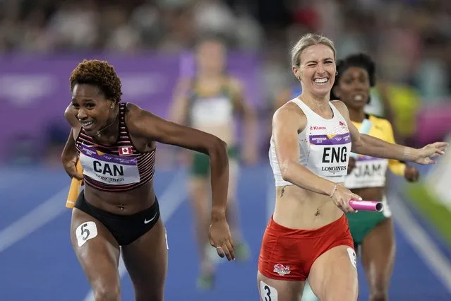 Team Canada's Kyra Constantine, left, and Team England's Jessie Knight cross the finish line of the Women's 4 x 400 meters relay during the athletics competition in the Alexander Stadium at the Commonwealth Games in Birmingham, England, Sunday, August 7, 2022. England crossed ahead but was later disqualified and Canada took the gold medal. (Photo by Manish Swarup/AP Photo)