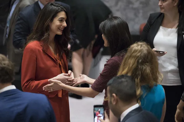 Human rights lawyer Amal Clooney, left, speaks to U.S. Ambassador to the United Nations Nikki Haley before a Security Council meeting Thursday, September 21, 2017, at United Nations headquarters. (Photo by Mary Altaffer/AP Photo)