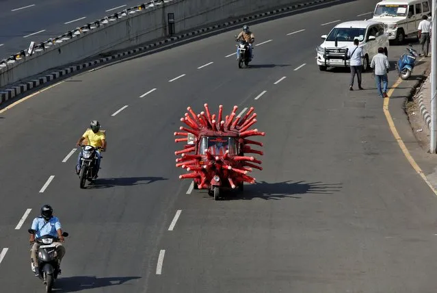 A man drives an auto-rickshaw depicting the coronavirus to create awareness about staying at home during a nationwide lockdown to slow the spreading of the coronavirus disease (COVID-19), in Chennai, April 23, 2020. (Photo by P. Ravikumar/Reuters)