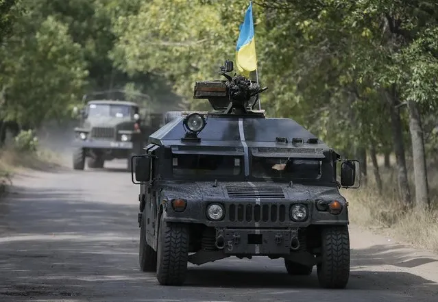 Ukrainian servicemen ride in an armoured vehicle in Kramatorsk, September 1, 2014. (Photo by Gleb Garanich/Reuters)