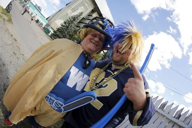 Winnipeg Blue Bomber fans and brothers Doug (L) and Will Streilein pose before the Riders vs Winnipeg Blue Bombers CFL football game in Regina, Saskatchewan September 6, 2015. The brothers came out to Regina for the Labour Day Classic football game. (Photo by David Stobbe/Reuters)