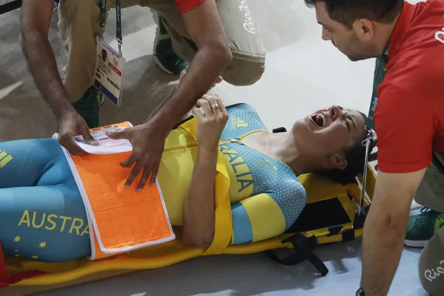 Melissa Hoskins of the Australian women's track cycling team is tended to after crashing during a training session inside the Rio Olympic Velodrome during the 2016 Olympic Games in Rio de Janeiro, Brazil, Monday, August 8, 2016. (Photo by Pavel Golovkin/AP Photo)