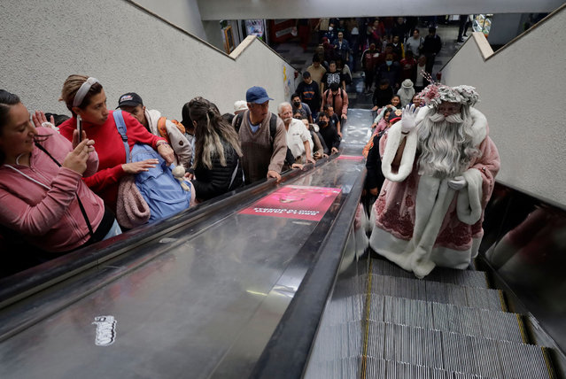 Jose Miguel Moctezuma Gonzalez, a street artist who specializes in human statues and make-up, is dressed as Father Christmas and is traveling around various stations of the Metro Collective Transport System in Mexico City on December 20, 2023. He is chatting with users and taking photos to make their journey to their destinations more pleasant on the eve of Christmas and New Year's Eve in the capital. (Photo by Gerardo Vieyra/NurPhoto/Rex Features/Shutterstock)