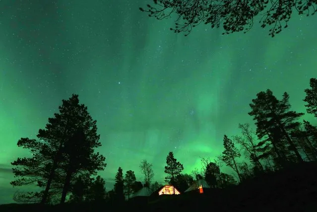 An Aurora Borealis (Northern Lights) is seen over a mountain camp north of the Arctic Circle, near the village of Mestervik late September 30, 2014. (Photo by Yannis Behrakis/Reuters)