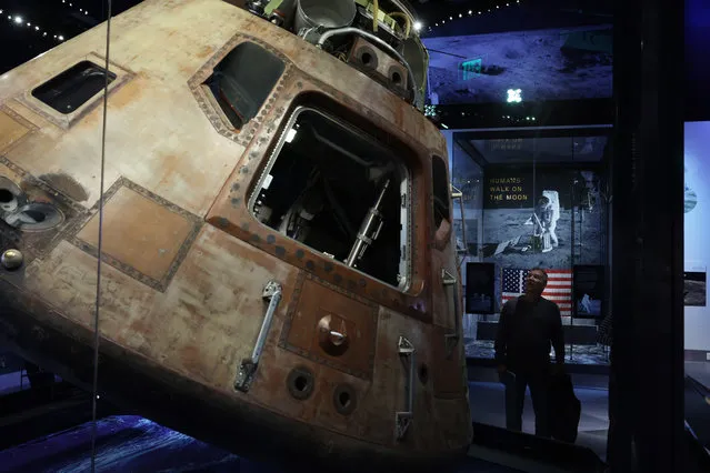 A visitor looks at Columbia, the Apollo 11 Command Module, at the “Destination Moon” exhibit at The Smithsonian National Air and Space Museum on its reopening on October 14, 2022 in Washington, DC. (Photo by Alex Wong/Getty Images)