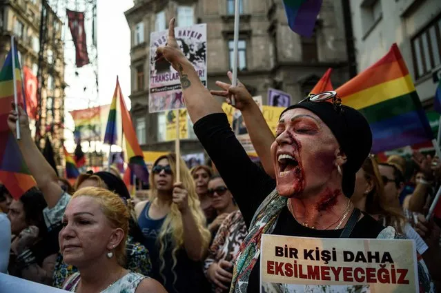 A LGBT member with make up on her face shouts slogans and gestures on August 21,2016 in Istanbul during a demonstration for the murdering of transgender activist Hande Kader, a 22-year-old transgender who was mutilated, burnt and murdered in Istanbul on last week. Nearly 200 militants of the transgender cause demonstrate in Istanbul to ask for justice after the murder of the transgender activist Hande Kader. It is the the second murder that horrified the Turkisk LGBT community after the killing, on August 4, 2016, of a Syrian refugee who was found dead with his body mutilated. (Photo by Ozan Kose/AFP Photo)