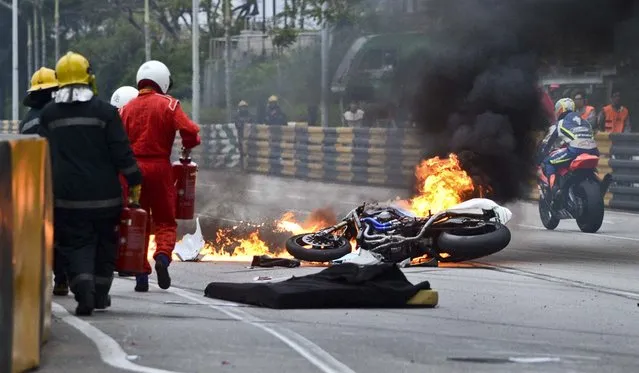 Rider Luis Filipe de Sousa Carreira's motorcycle burns after a crash during qualifying for the Macau Grand Prix, in Macau, November 15, 2012. Carreira died from injuries sustained in the crash. (Photo by Xinhua Cheong Kam Ka/China News Agency)